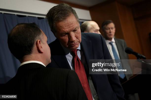 Gov. John Kasich confers with an aide during a press conference on health care February 23, 2018 in Washington, DC. The three governors unveiled a...