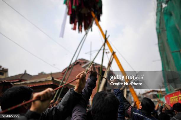 Members of Manandhar Guthi erecting ceremonial Bamboo Log known as &quot;Chir&quot; along with the vibrant cloth strips, which representing good luck...