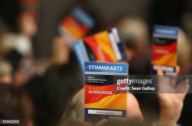 Delegates cast their votes on a preliminary issue at a special meeting of the German Christian Democrats at Hotel Berlin, Berlin on October 26, 2009...