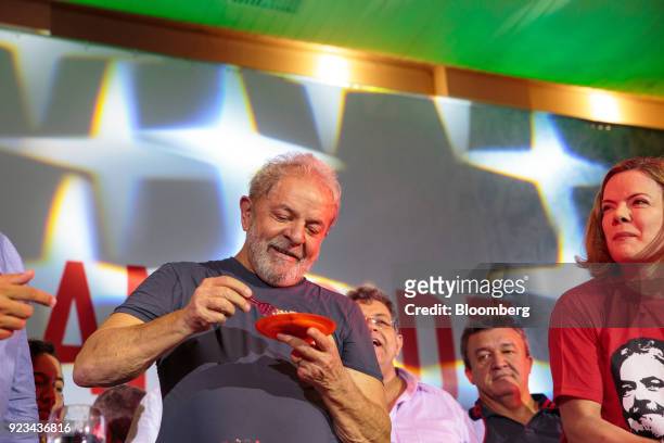 Luiz Inacio Lula da Silva, Brazil's former president, eats a piece of cake during the 38th Anniversary celebration of the Workers' Party event in Sao...