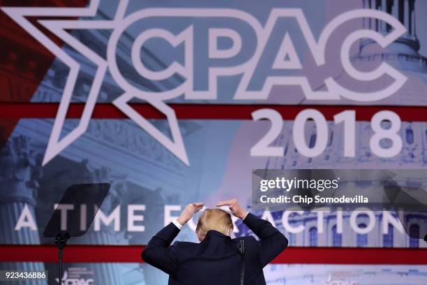 President Donald Trump jokes about covering his bald spot while addressing the Conservative Political Action Conference at the Gaylord National...