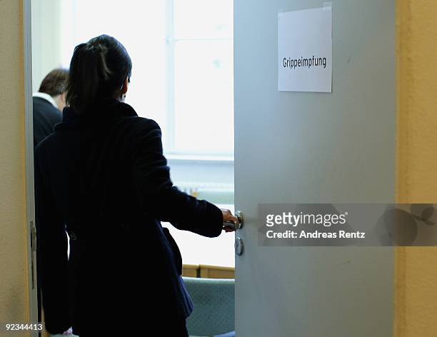 Nurse walks in a room to get an injection against H1N1 swine flu at the Charite clinical center on October 26, 2009 in Berlin, Germany. German...