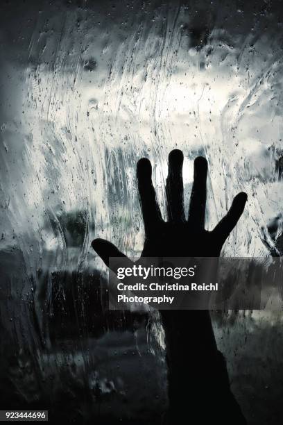 close-up of human hand touching glass - human trafficking pictures stock pictures, royalty-free photos & images