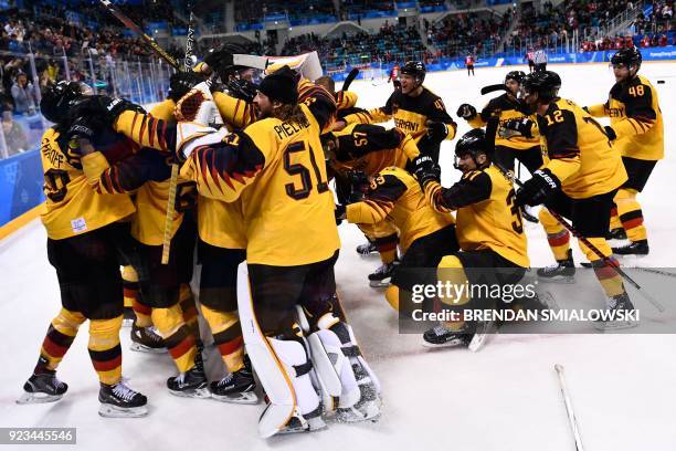 Germany's players celebrate winning the men's semi-final ice hockey match between Canada and Germany during the Pyeongchang 2018 Winter Olympic Games...