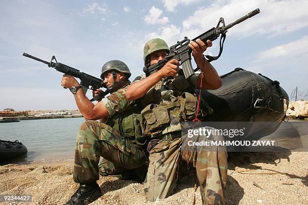 Lebanese Army troops take a combat position during a joint amphibious drill with soldiers from the Italian contingent serving with the United Nations...
