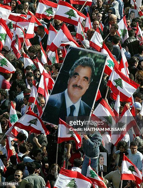 The picture of slain Lebanese Prime Minister Rafiq Hariri is seen amind a sea of Lebanese flags Beirut's Martyrs Square 14 March 2005. Almost a...
