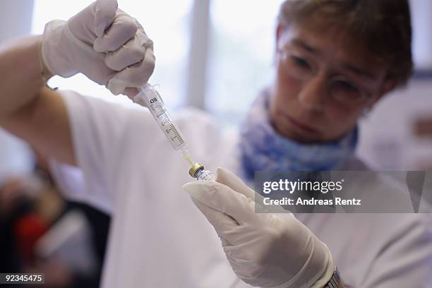 Nurse prepares the dose rate of H1N1 swine flu vaccination Pandemic at the Charite clinical center on October 26, 2009 in Berlin, Germany. German...