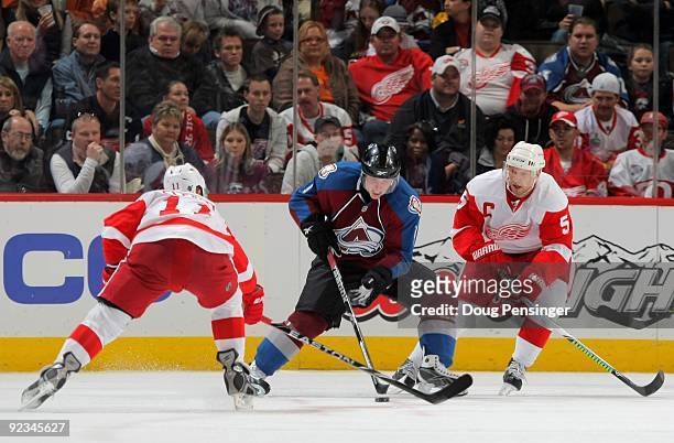 Matt Duchene of the Colorado Avalanche controls the puck against Nicklas Lidstrom and Dan Cleary of the Detroit Red Wings during NHL action at the...
