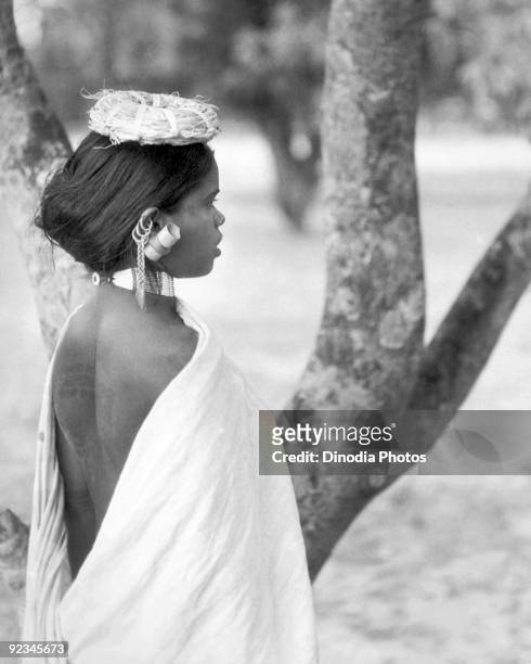 Rural Indian girl of the Santhal tribe wearing a white dress in Bihar, India, circa 1945.