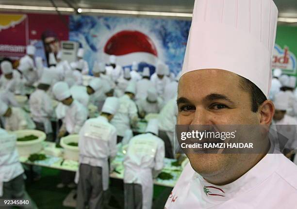 Lebanon's famous chef Ramzi Choueiry poses for a picture as chefs prepare a giant tabbouleh salad to set a new world record in Beirut on October 25,...