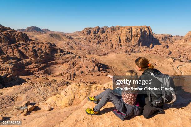 mother and daughter admiring the roman amphitheatre in petra - rocky point stock pictures, royalty-free photos & images