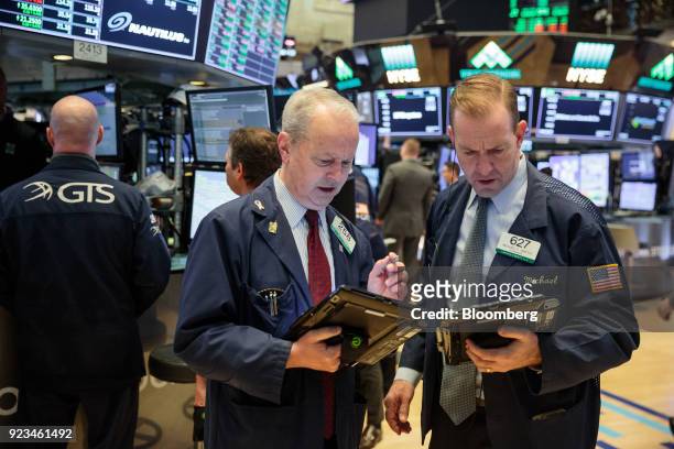 Traders work on the floor of the New York Stock Exchange in New York, U.S., on Friday, Feb 23, 2018. U.S. Stocks rose with Treasuries and the dollar...
