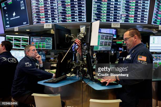 Traders work on the floor of the New York Stock Exchange in New York, U.S., on Friday, Feb 23, 2018. U.S. Stocks rose with Treasuries and the dollar...