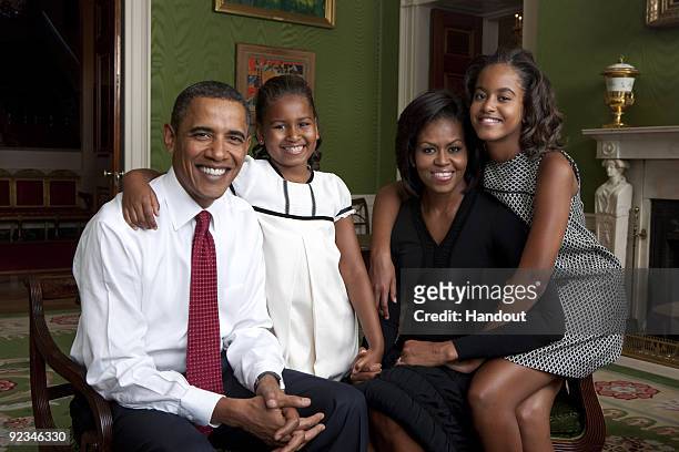 In this handout form the White House, U.S. President Barack Obama, daughter Malia Obama, first lady Michelle Obama and daughter Sasha Obama sit for...