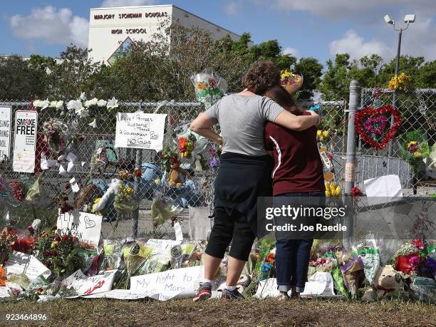 Margarita Lasalle , the budget keeper, and Joellen Berman, Guidance Data Specialist, look on at the memorial in front of Marjory Stoneman Douglas...