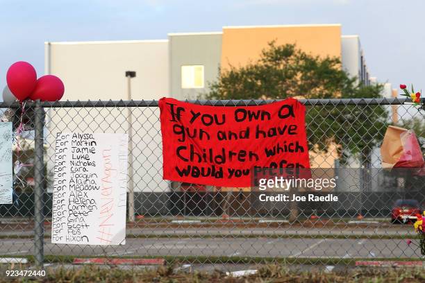 Sign is seen on the fence around Marjory Stoneman Douglas High School in front of the freshman dorm where a mass shooting took place on campus on...