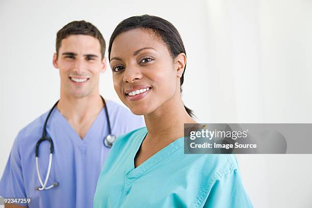 surgeons in scrubs - doctor white background stock pictures, royalty-free photos & images