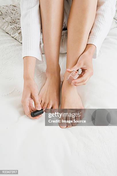 woman painting toenails - pretty toes and feet stock-fotos und bilder