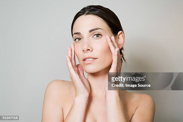 young woman touching face - hands in the face stock pictures, royalty-free photos & images