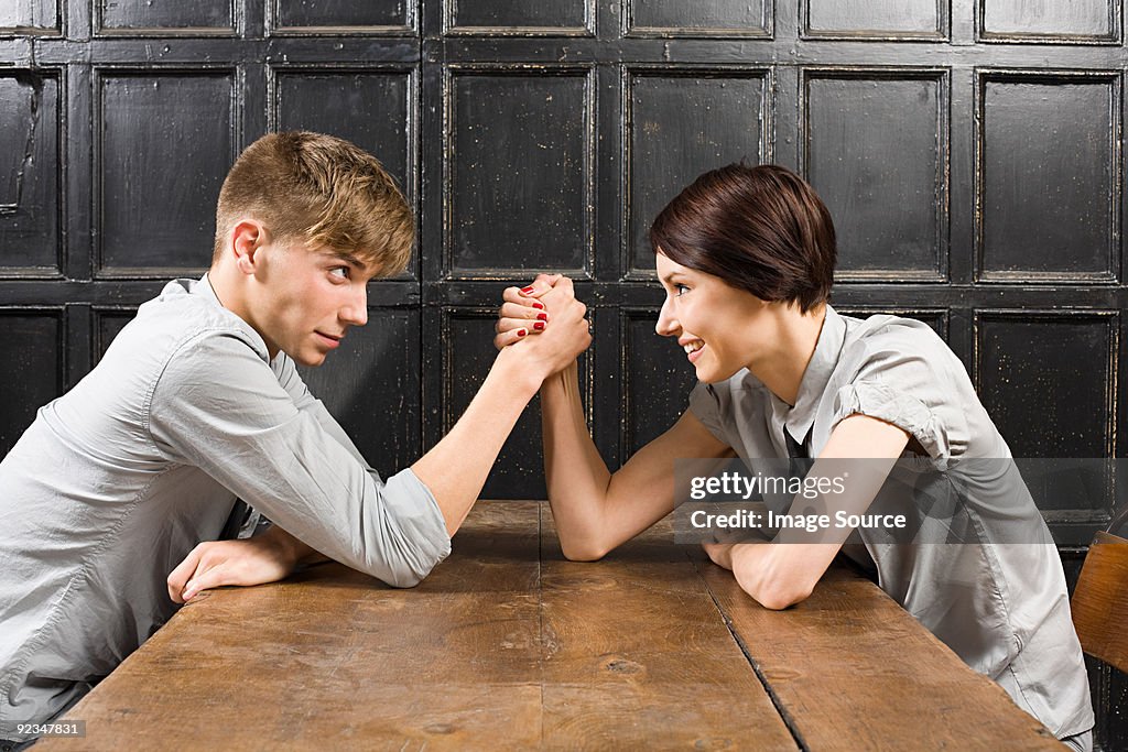 Young couple arm wrestling