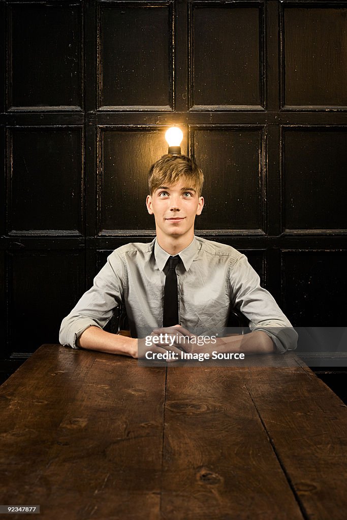 Teenage boy with lightbulb on head