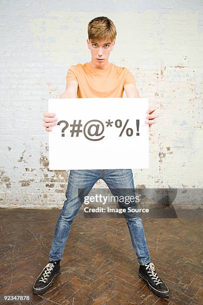 teenager boy holding sign - raute stock-fotos und bilder