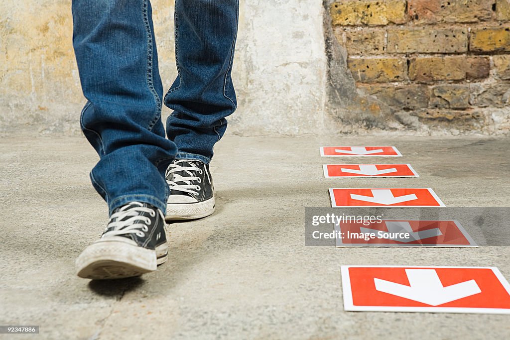 Person walking by arrows