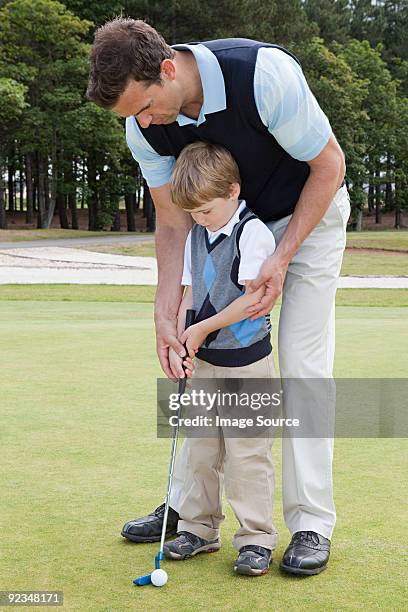 father teaching his son golf - east lothian stock pictures, royalty-free photos & images