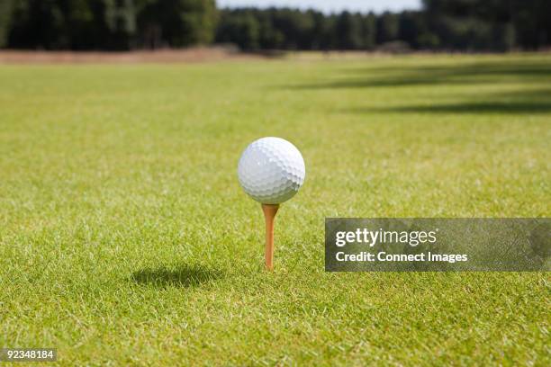 golf ball and tee - golf ball stock pictures, royalty-free photos & images