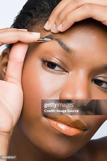 young woman plucking eyebrows - pincett bildbanksfoton och bilder