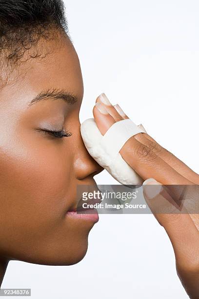 woman applying face powder - powder puff stock pictures, royalty-free photos & images
