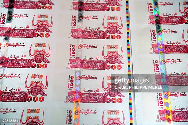 Picture taken on October 26, 2009 in Lyon, central France shows plates of false printed Algerian Dinar banknotes, shown during a press conference...