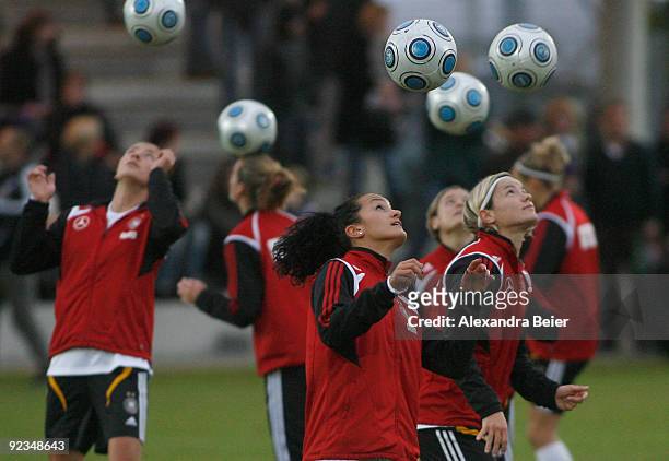 Fatmire Bajramaj and Saskia Bartusiak of the women's German national football team warms up during a training session on October 26, 2009 in...