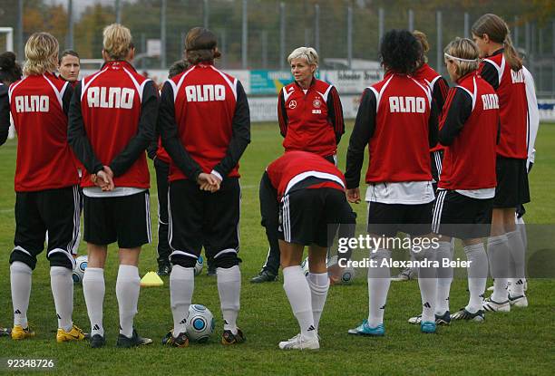 Team coach Silvia Neid of the women's German national football team talks to her players warming up during a training session on October 26, 2009 in...