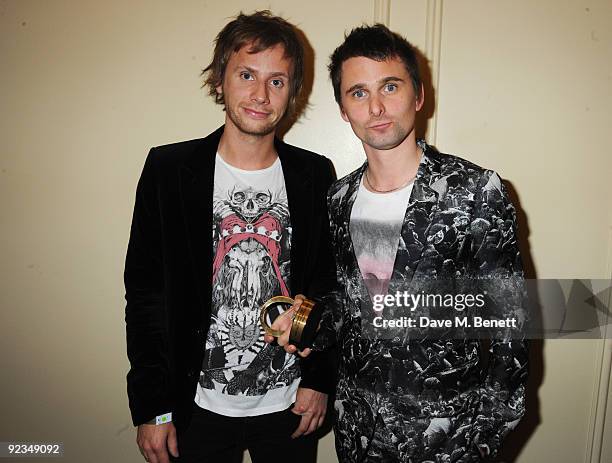 Dominic Howard and Matt Bellamy of Muse pose with the Best Act In The World Today Award at The Q Awards, at the Grosvenor House on October 26, 2009...