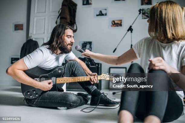 playful couple making music - woman in guitar making studio stock pictures, royalty-free photos & images