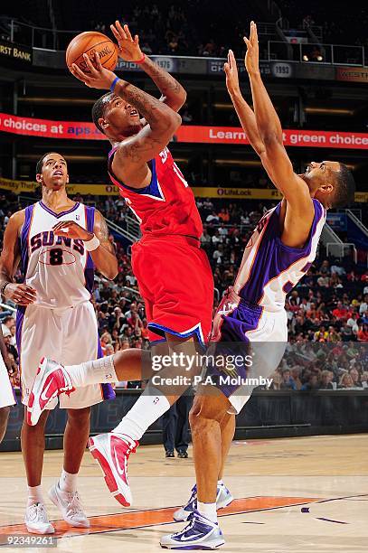 Marreese Speights of the Philadelphia 76ers puts up a shot against Grant Hill of the Phoenix Suns during the preseason game on October 16, 2009 at US...