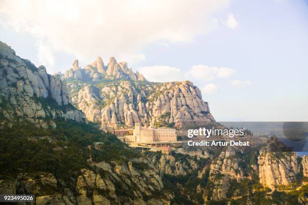 the monastery of montserrat between the stunning rock formations mountain in catalonia. - montserrat spanje stockfoto's en -beelden