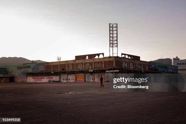 Petroleos de Venezuela SA worker walks through an empty lot in Puerto La Cruz, Anzoategui state, Venezuela, on Wednesday, Feb. 7, 2018. Hunger is...