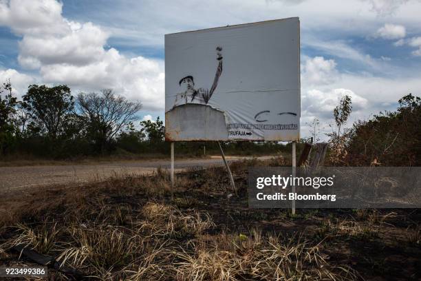 Decaying Orinoco Petroleum Belt banner featuring an image of the late Venezuelan president Hugo Chavez stands on a roadway near Puerto La Cruz,...