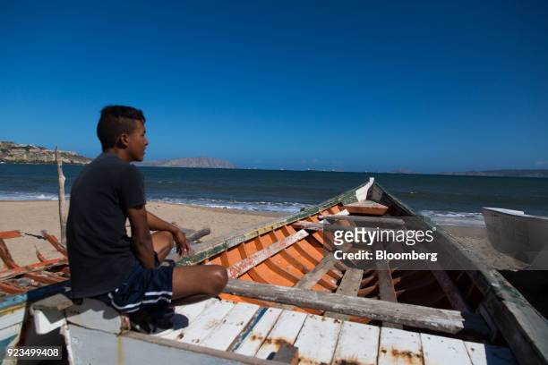 Person sits in a fishing boat on a beach in Puerto La Cruz, Anzoategui state, Venezuela, on Wednesday, Feb. 7, 2018. Hunger is hastening the ruin of...