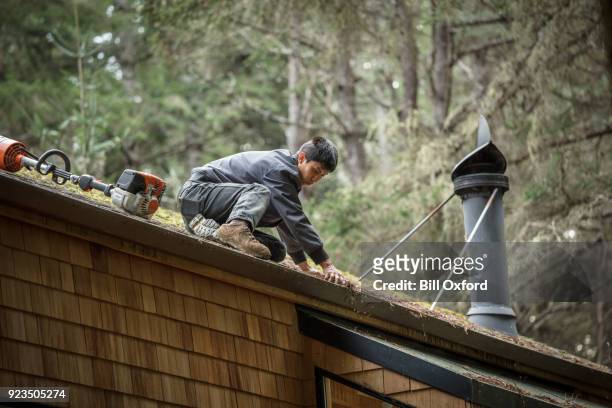 cleaning rain gutter on roof - rain gutter imagens e fotografias de stock