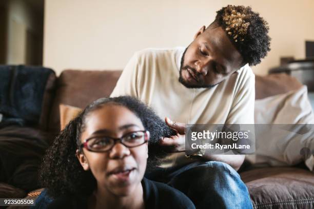 Supportive Father Helps Daughter Braid Hair