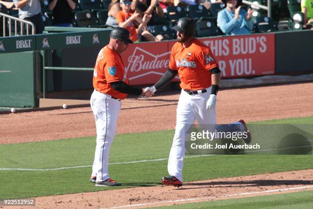 Scott Van Slyke is congratulated by third base coach Fredi Gonzalez of the Miami Marlins as he rounds the bases after hitting a seventh inning grand...