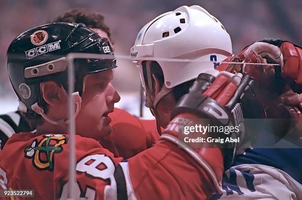 Steve Larmer of the Chicago Black Hawks skates against Walt Poddubny of the Toronto Maple Leafs during NHL Stanley Cup game action on April 12, 1986...