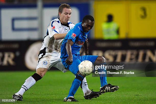 Arne Feick of Bielefeld and Rolf-Christel Guie-Mien of Paderborn battle for the ball during the Second Bundesliga match between SC Paderborn and...