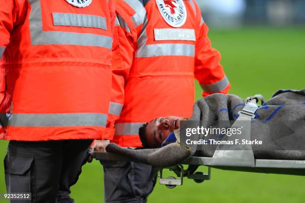 Markus Bollmann of Bielefeld is brought off the pitch by first-aider during the Second Bundesliga match between SC Paderborn and Arminia Bielefeld at...