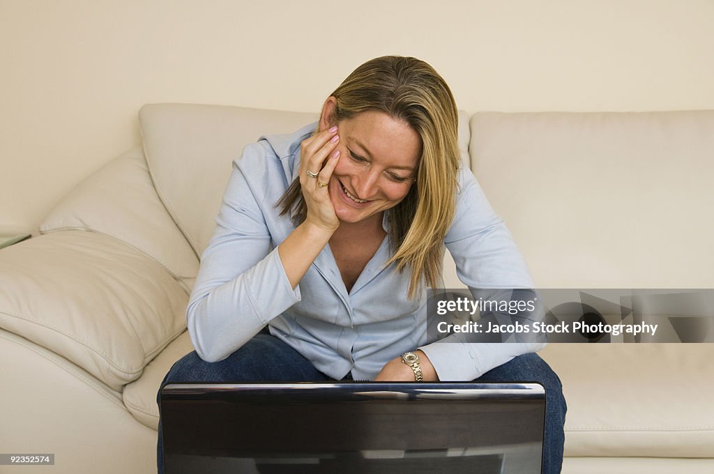 Woman at home using laptop
