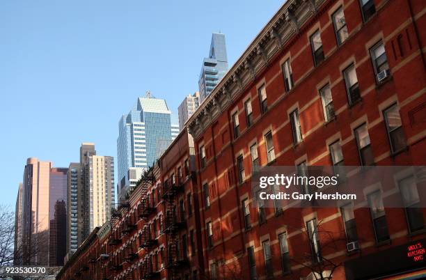 Old red brick buildings along 49th Street are illuminated by the late afternoon sun along with new buildings in Times Square on February 21, 2018 in...