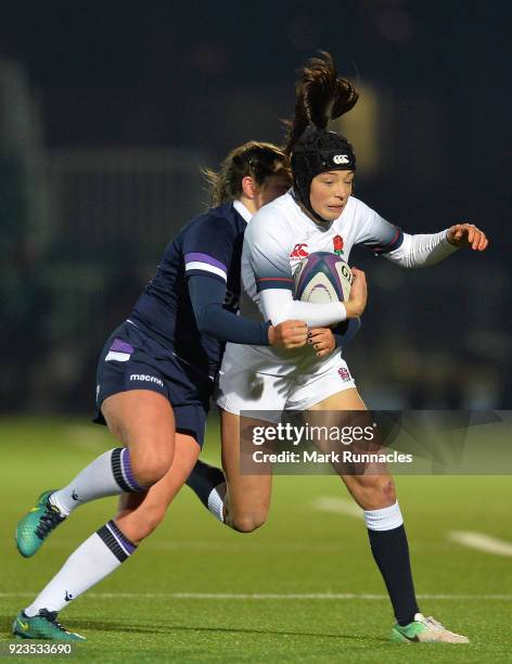 Kelly Smith of England is tackled by Lisa Thomson of Scotland during the Natwest Women's Six Nations match between Scotland Women and England Women...